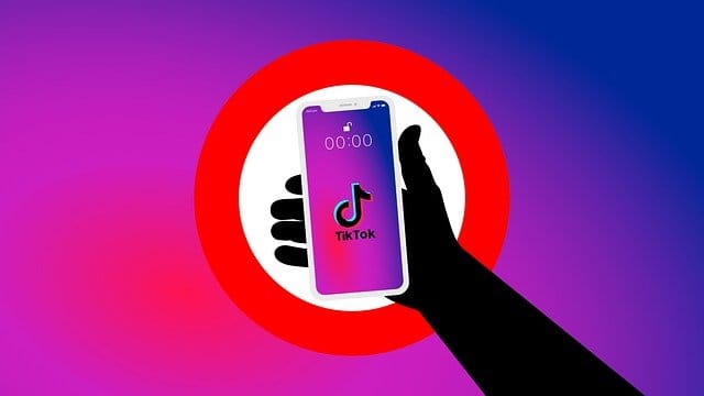TikTok app on smartphone screen, digital entertainment, social media, trending music, video sharing platform, mobile device, user-generated content, popular app, social networking, viral videos, online content creation, smartphone technology.