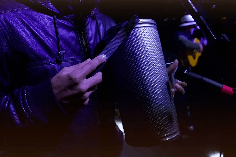 Music performance with a focus on recording or mixing using professional audio equipment at a live event or studio.