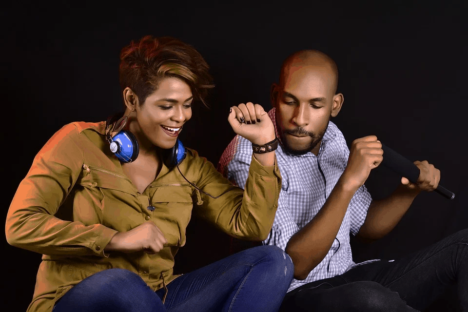 Music lovers dancing to live DJ performance at a concert festival.