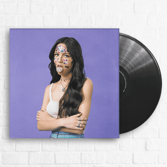 Album cover of a female artist with face stickers and long dark hair, purple background, vinyl record, music promotion, indie music, album artwork, Hypebot relevant music industry imagery.