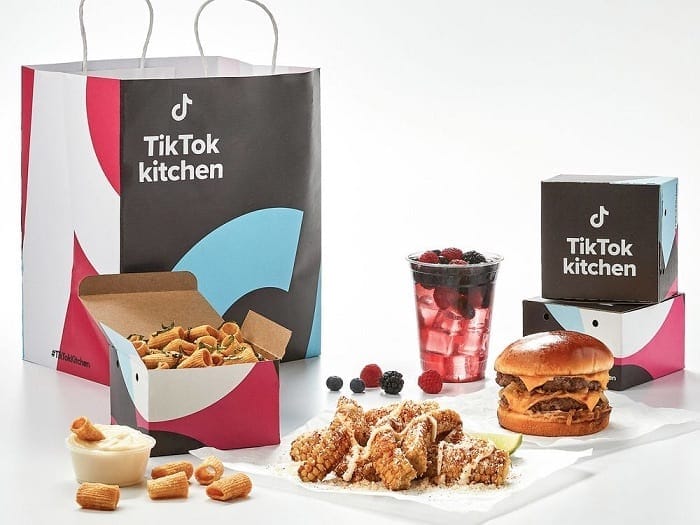 TikTok Kitchen food packaging with Chinese takeout boxes, burger, fried chicken, and berries, highlighting innovative food branding and delivery trends, promoting TikTok food delivery services.