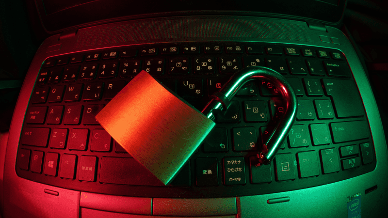 Lock and padlock symbol on laptop keyboard representing cybersecurity and data protection concepts, with red and green lighting effects - Hypebot.