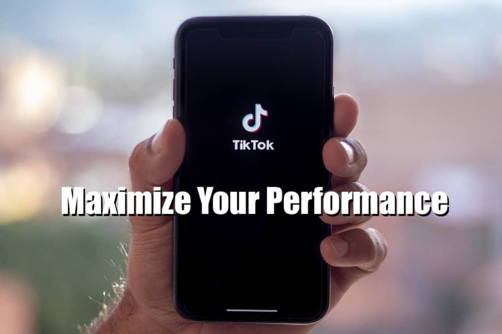TikTok app on smartphone screen with the text "Maximize Your Performance" overlay, focusing on social media marketing, content creation, and digital performance optimization.