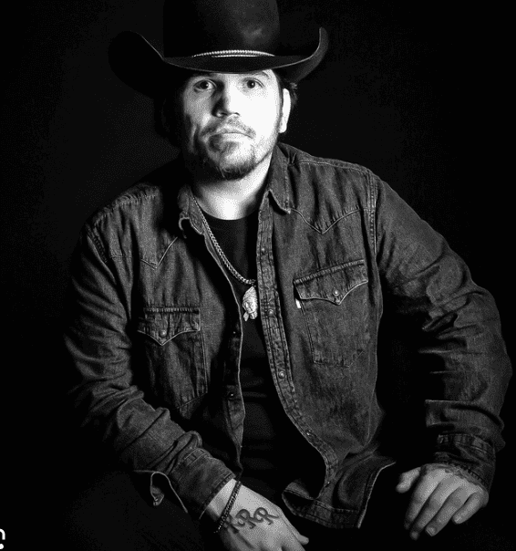 Cowboy hat, denim jacket, music artist, black and white portrait, Hypebot article feature.
