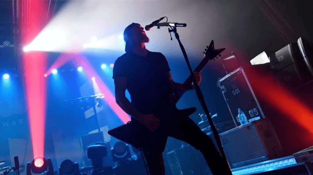 Vibrant electric guitarist performing live on stage with colorful concert lighting, creating an energetic atmosphere. Perfectly captures the essence of live music and concert experience.