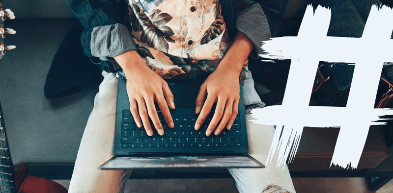 Laptop user typing at a desk, digital music industry, online music marketing, music industry technology, Hypebot website focus.