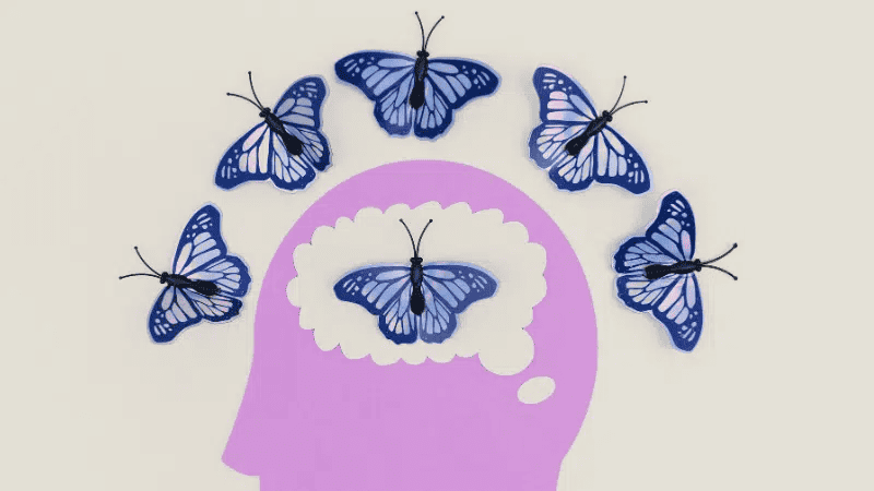 Blue butterflies surrounding a purple human head outline, symbolizing creativity, ideas, and mental innovation. Inspirational image representing thinking, imagination, and brain activity.