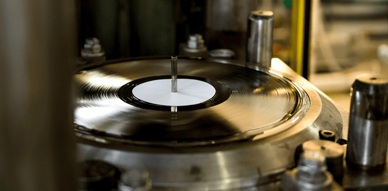Vinyl record spinning on turntable, music production, DJ equipment, audio technology, Hypebot article feature.