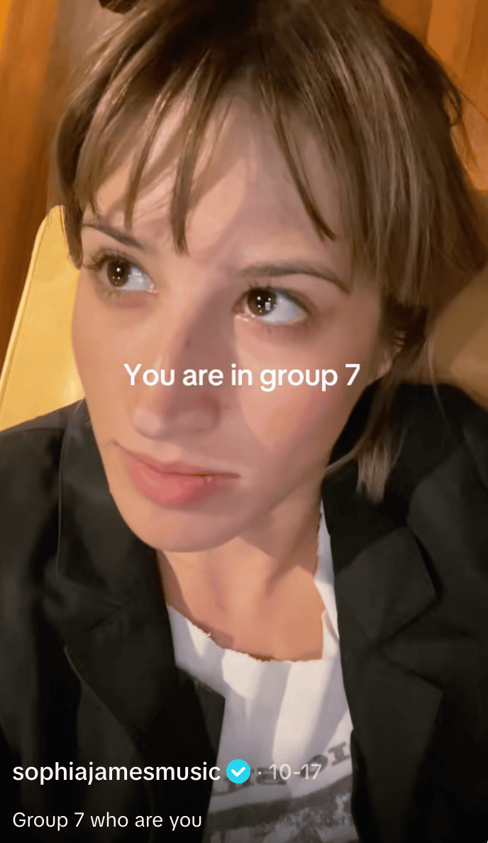Group 7 music fan engaging with interactive social media content about music groups and fan communities Hypebot, music industry news, fan engagement, social media trends, digital marketing strategies for musicians and artists A close-up of a woman with brown hair and big eyes, lying down with a text overlay that reads "You are in group 7." The image is from a social media platform highlighting fan group identification, music fan engagement, and digital community participation in the modern music industry.
